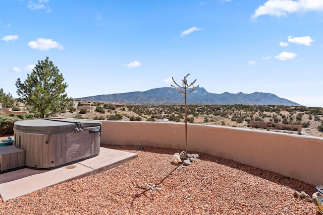 exterior space featuring a hot tub and a mountain view