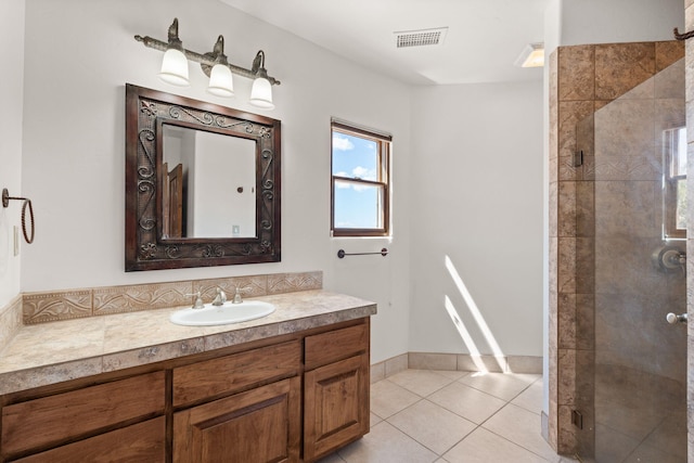 bathroom featuring vanity, tile patterned floors, a stall shower, and visible vents
