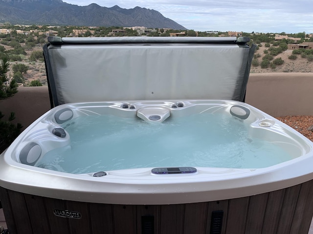 exterior space featuring washer / dryer, a mountain view, and a jacuzzi