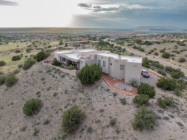 birds eye view of property featuring a rural view, a mountain view, and view of desert