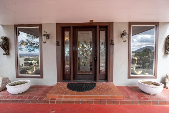 property entrance with stucco siding