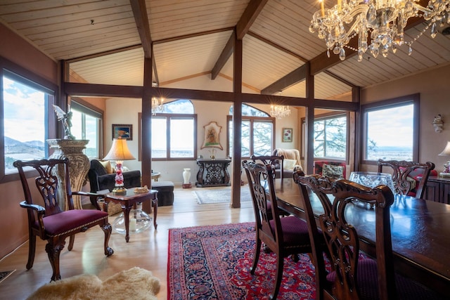 dining space featuring visible vents, vaulted ceiling with beams, an inviting chandelier, and wood finished floors