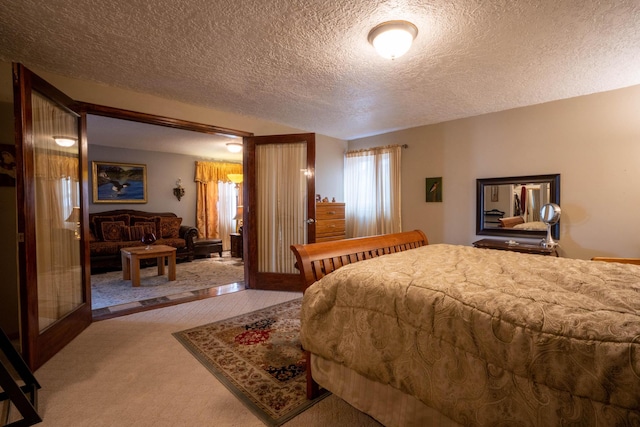 bedroom with carpet flooring and a textured ceiling