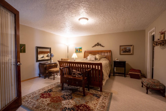 bedroom featuring baseboards, a textured ceiling, and carpet flooring