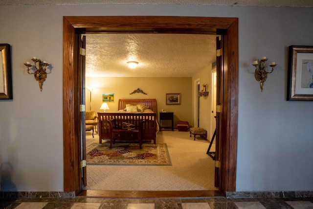 bedroom featuring a textured ceiling and carpet