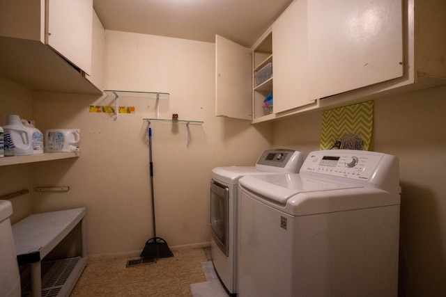 clothes washing area featuring cabinet space, baseboards, and separate washer and dryer