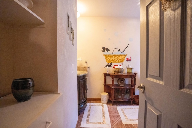 bathroom featuring vanity, tile patterned floors, and baseboards