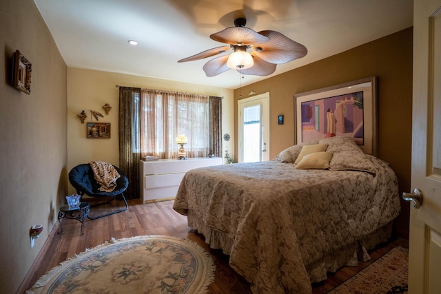 bedroom with a ceiling fan and wood finished floors