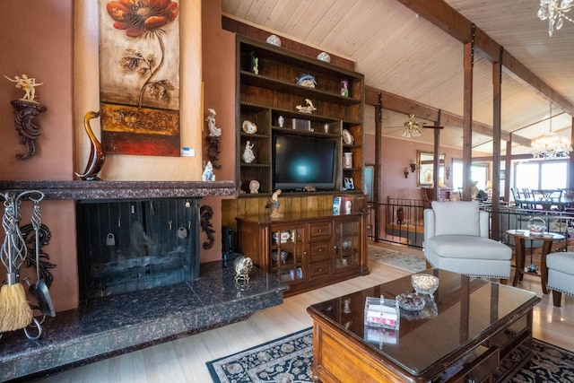 living area with built in shelves, vaulted ceiling with beams, wooden ceiling, an inviting chandelier, and wood finished floors