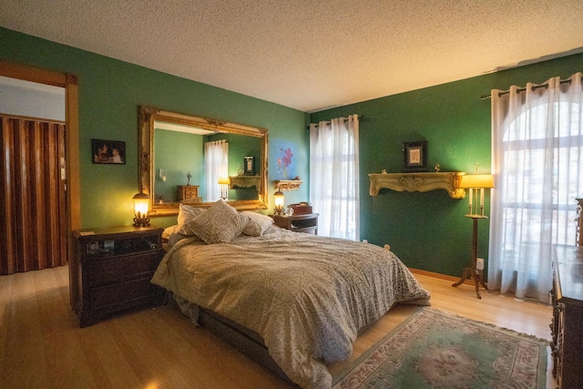 bedroom featuring a textured ceiling and wood finished floors