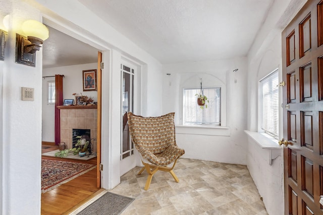 sitting room featuring a tile fireplace