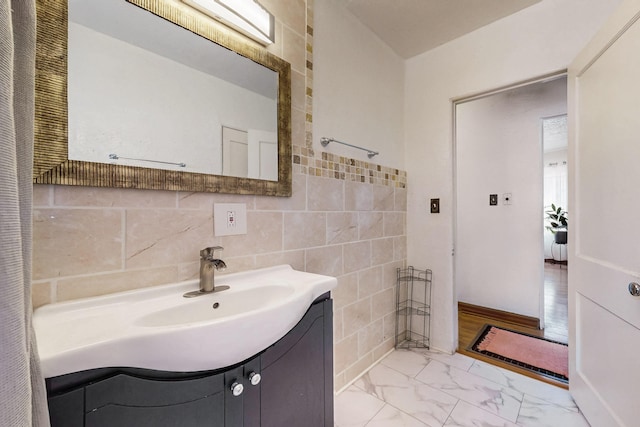 bathroom featuring vanity, tile walls, and marble finish floor