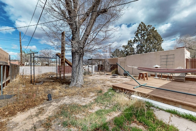 view of yard with a deck and fence