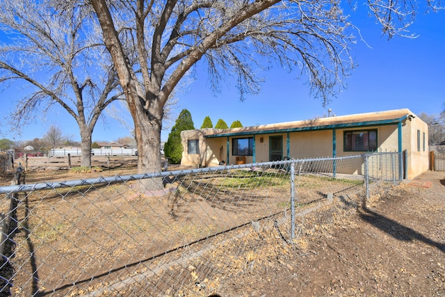 single story home featuring a fenced front yard and stucco siding