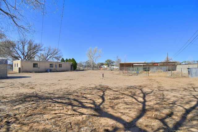 view of yard featuring an outbuilding and fence