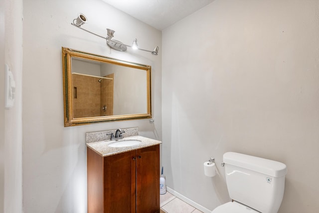 bathroom with vanity, baseboards, walk in shower, tile patterned floors, and toilet