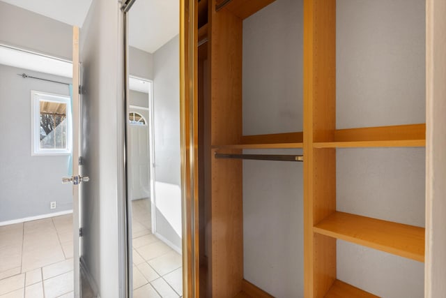 interior space with tile patterned floors and baseboards