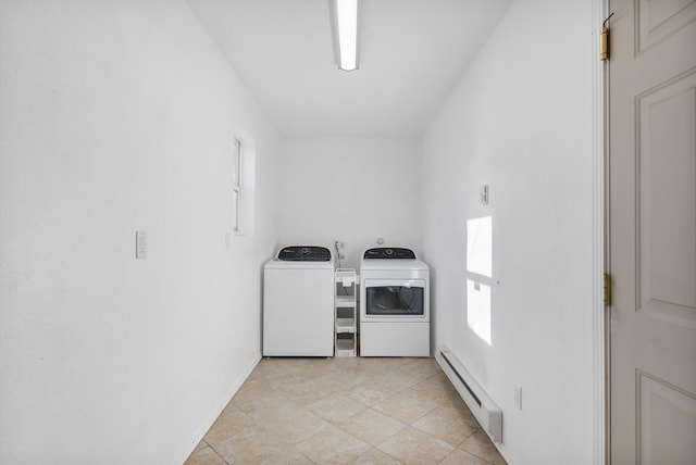 washroom with a baseboard heating unit, baseboards, light tile patterned floors, laundry area, and washer and dryer