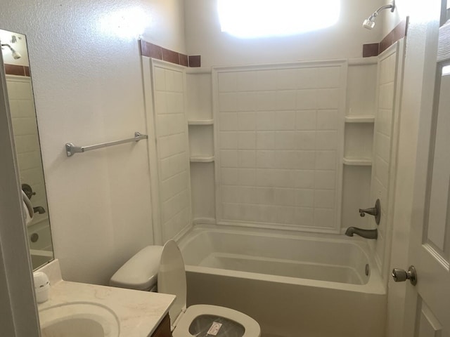 bathroom with toilet, vanity, and washtub / shower combination