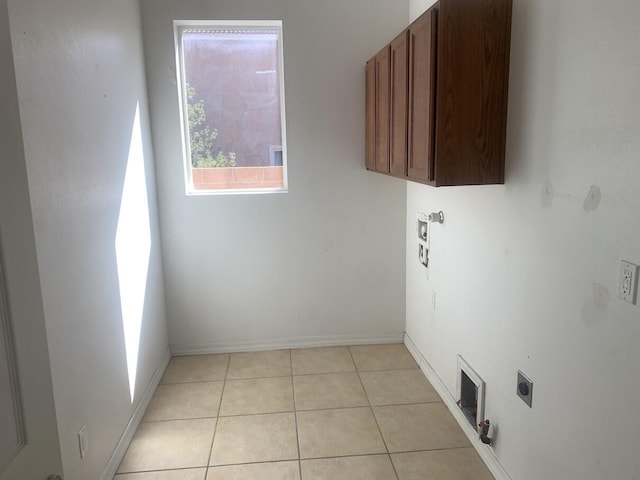 laundry room featuring washer hookup, cabinet space, light tile patterned floors, baseboards, and hookup for an electric dryer
