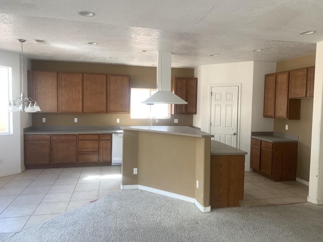 kitchen featuring light tile patterned floors, visible vents, brown cabinets, and white dishwasher