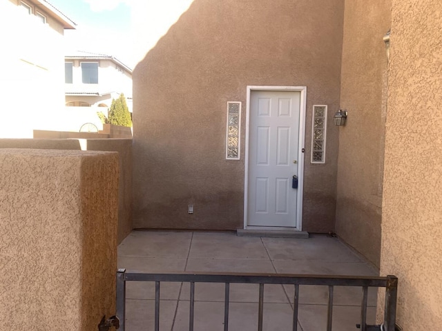 entrance to property featuring stucco siding
