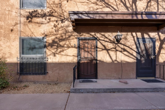 doorway to property with stucco siding