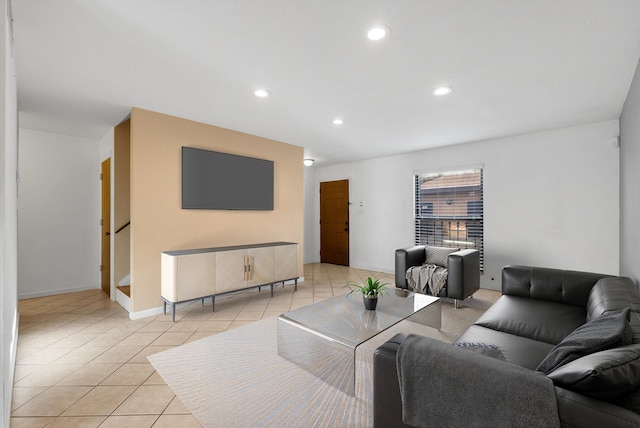 living area featuring light tile patterned flooring, recessed lighting, and baseboards