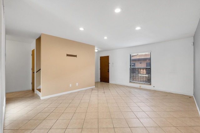 empty room with light tile patterned floors, recessed lighting, and baseboards