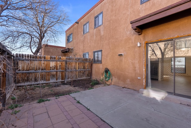 view of patio featuring fence