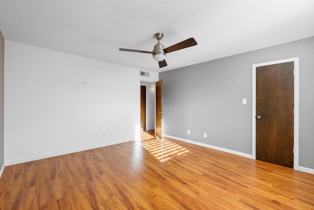 unfurnished room with visible vents, baseboards, light wood-style floors, and a ceiling fan