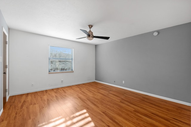 unfurnished bedroom featuring light wood finished floors, a ceiling fan, and baseboards