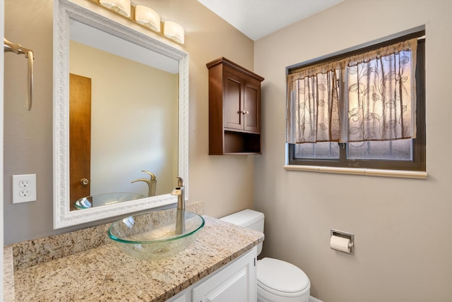 bathroom featuring toilet and vanity