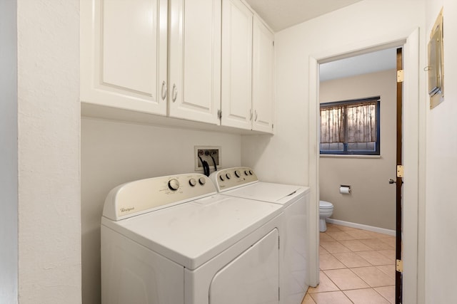 laundry room featuring baseboards, cabinet space, independent washer and dryer, and light tile patterned flooring