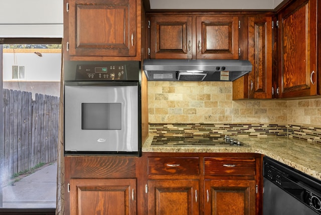 kitchen with under cabinet range hood, visible vents, appliances with stainless steel finishes, and tasteful backsplash