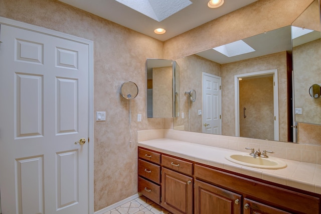 bathroom with vanity and a skylight