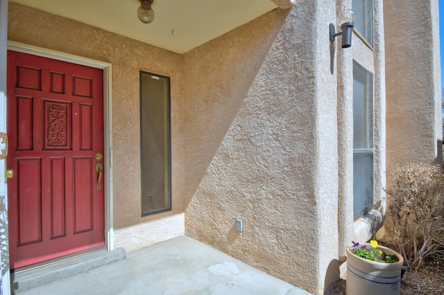 doorway to property with stucco siding