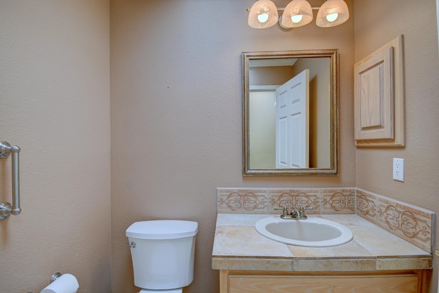 bathroom featuring toilet and vanity