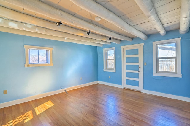 506 Onate Pl, Santa Fe, NM 87501 - empty room with beam ceiling, wood ceiling, wood finished floors, and baseboards