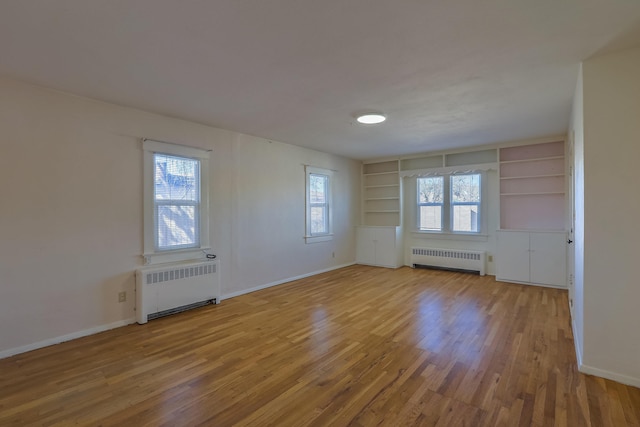 506 Onate Pl, Santa Fe, NM 87501 - unfurnished room featuring a wealth of natural light, radiator, and wood finished floors