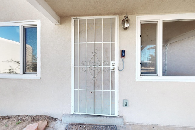 view of exterior entry with stucco siding