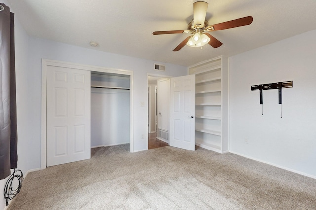 unfurnished bedroom with visible vents, baseboards, carpet, and a ceiling fan