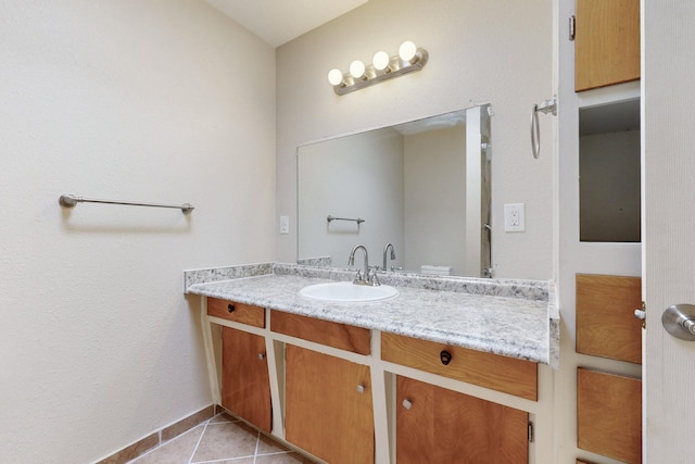 bathroom with tile patterned floors, baseboards, and vanity