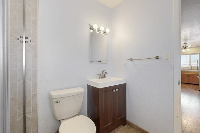 full bathroom with toilet, vanity, and ceiling fan