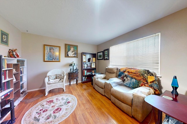 living area with wood finished floors and baseboards