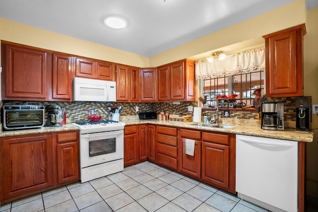 kitchen featuring a toaster, decorative backsplash, light tile patterned flooring, white appliances, and a sink