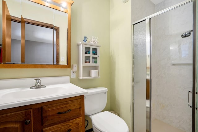 full bathroom featuring a shower stall, vanity, and toilet