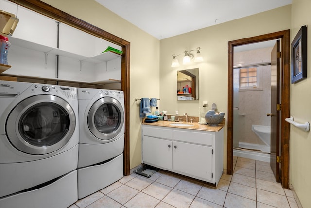 laundry room featuring a sink, wet bar, separate washer and dryer, and light tile patterned floors