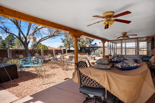 view of patio featuring outdoor dining space, a fenced backyard, an outdoor living space with a fire pit, and ceiling fan