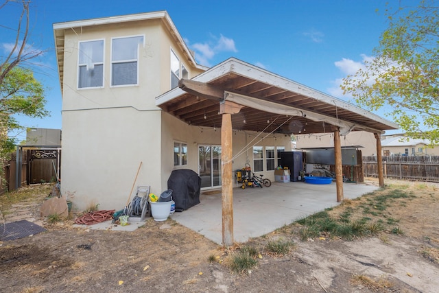 101 Colinas Ave NE, Albuquerque, NM 87113 - back of property featuring stucco siding, a patio, and fence
